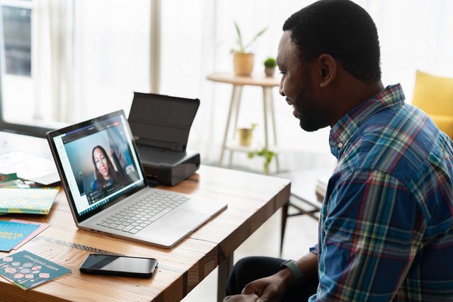 Man on Zoom managing a remote team.