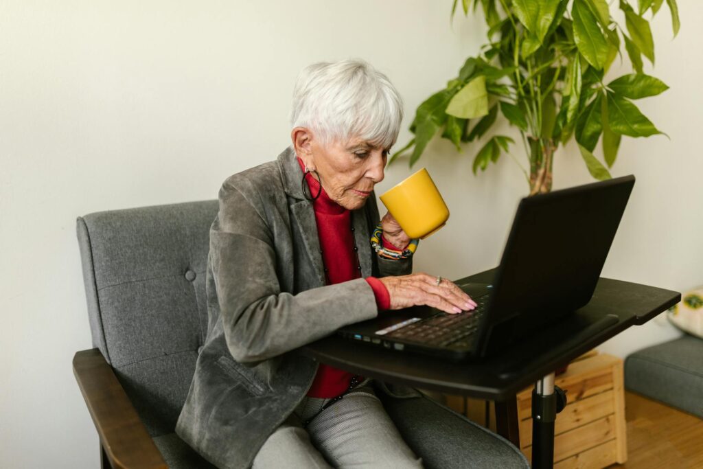 A businesswoman on her laptop while drinking coffee