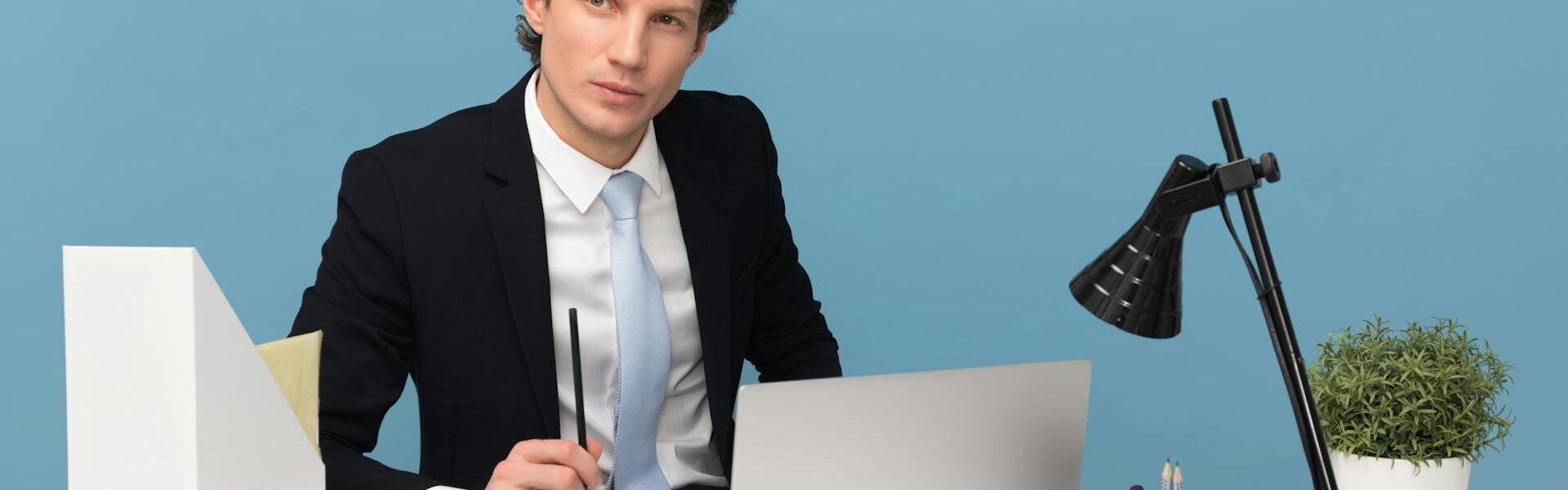 Business professional sitting at a desk with a laptop