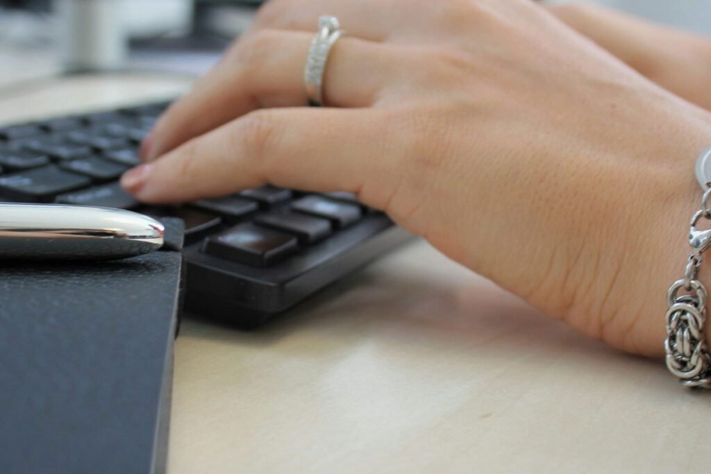 A receptionist working on her computer at a desk