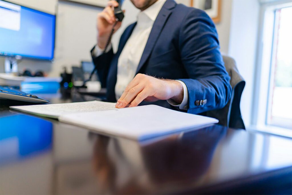 Corporate legal assistant going over scheduling on the phone