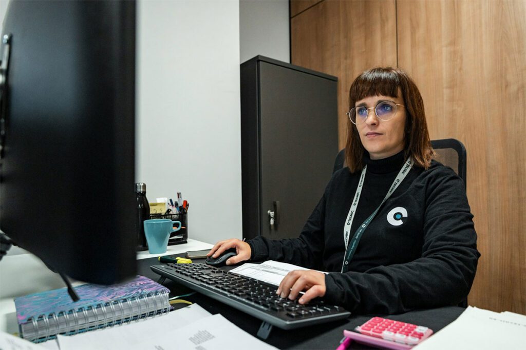 Membership coordinator working at computer updating member accounts